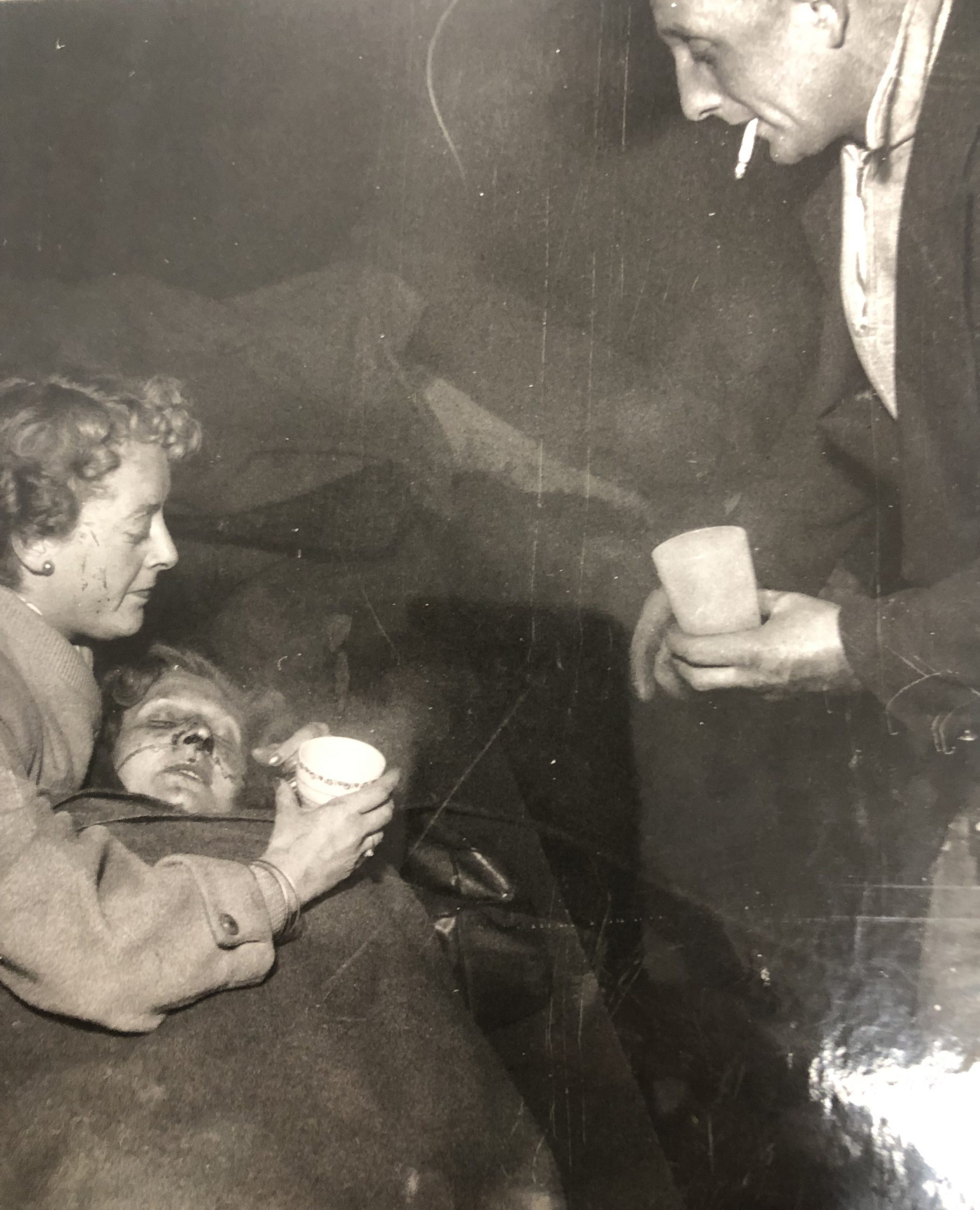 3. Waiting for the ambulance: an injured woman, Mrs Connie White, is given sips of tea.