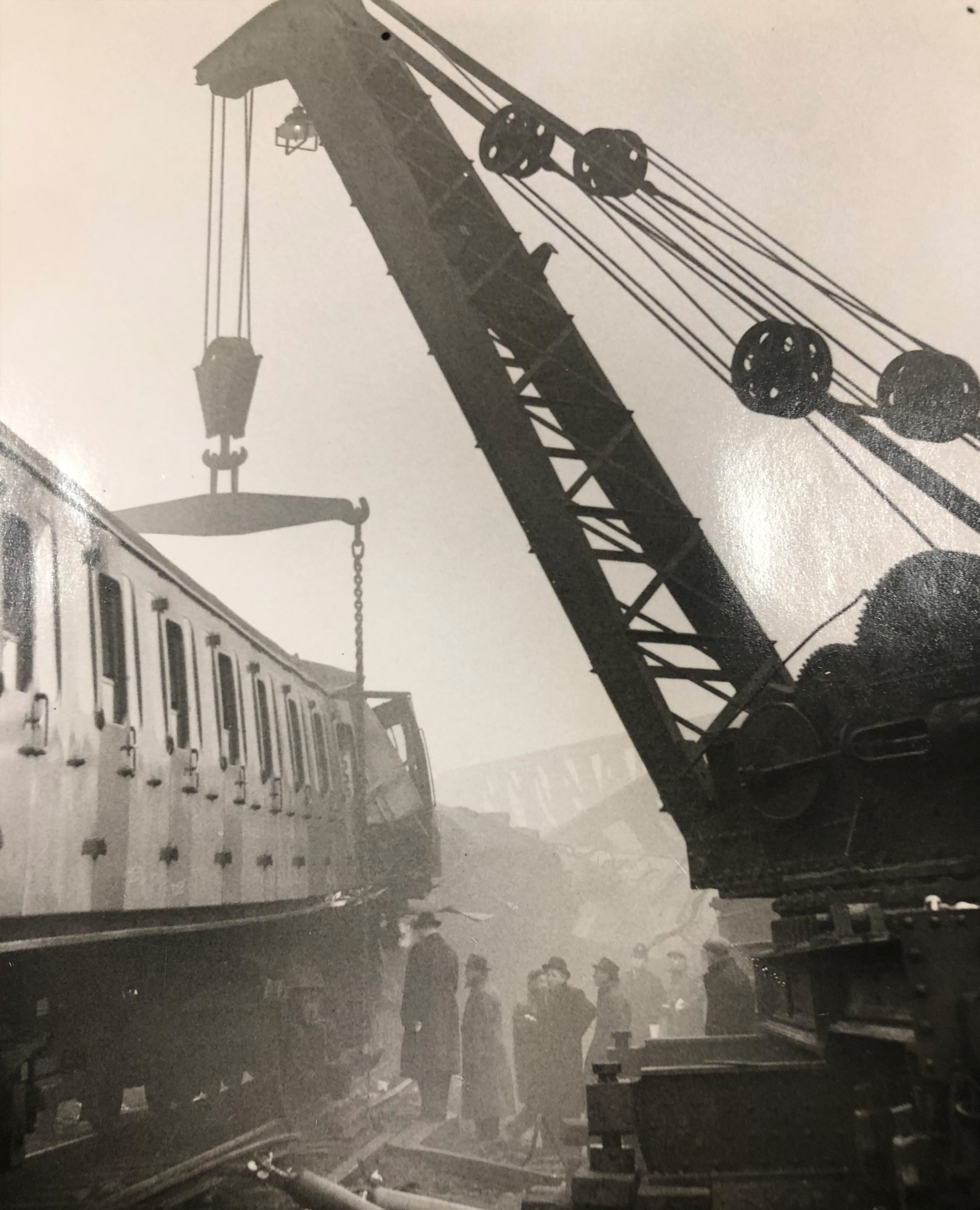 Clearing wreckage: a heavy-lift breakdown crane lifts a carriage.